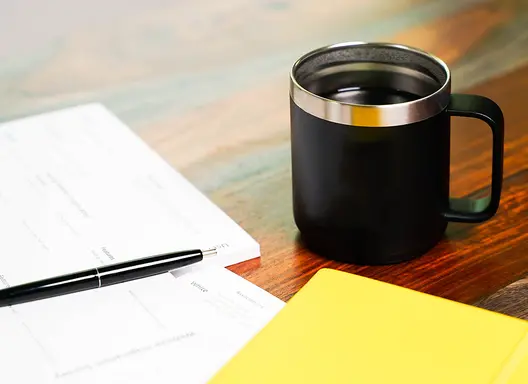 Image of paperwork and coffee mug